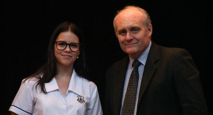 senior student informal uniform standing next to principal peter south