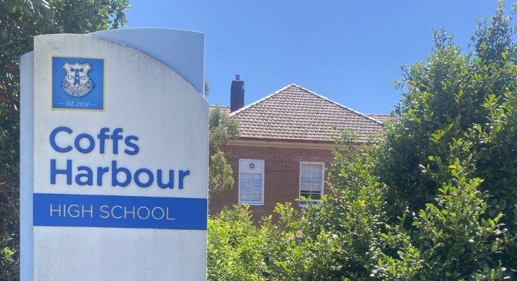 coffs harbour high school sign with main building and trees in background