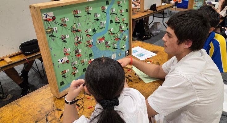 two senior students conducting electrical experiment